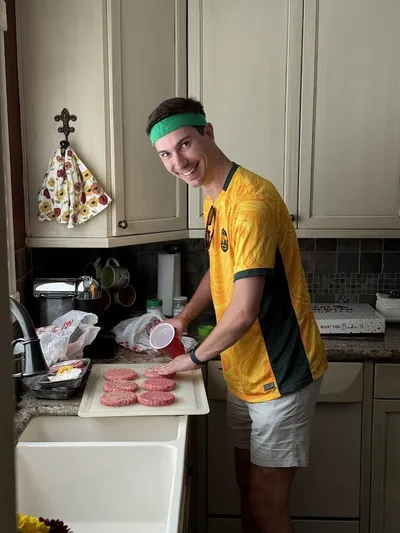 Self-serve burger bar with toppings and sides set up for a 30th birthday party