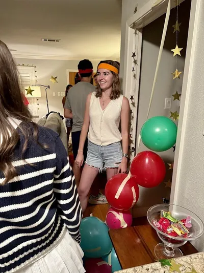 Close-up of guests wearing orange team headbands at a Go for the Gold themed 30th birthday party