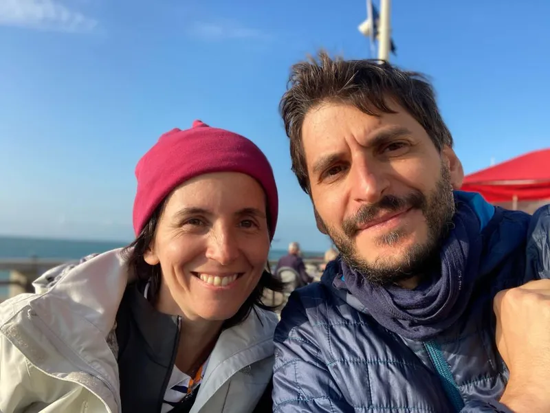 man and woman smiling for a photo outdoors