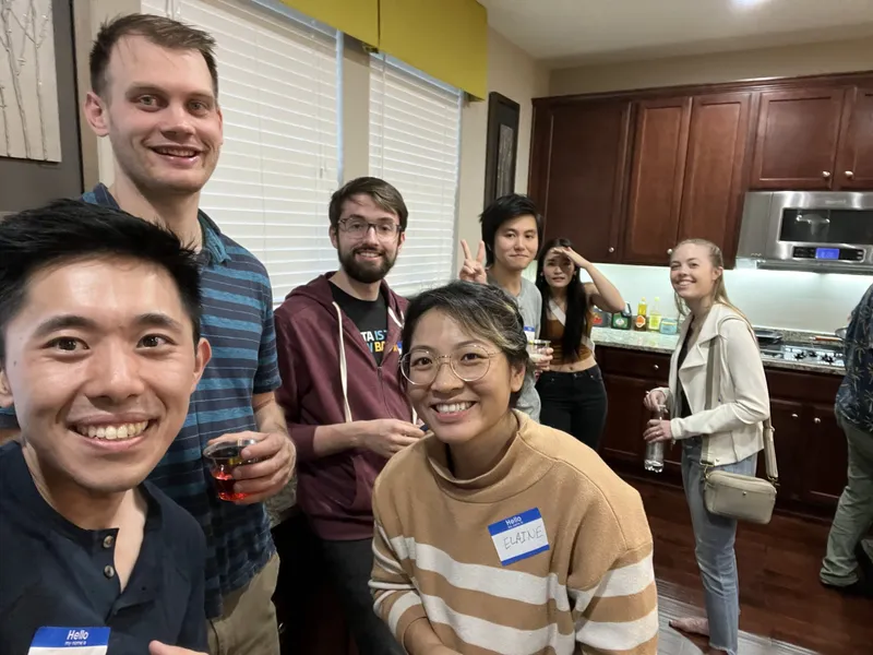 group of people smiling on camera
