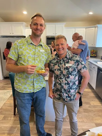 a photo of two men wearing name tags