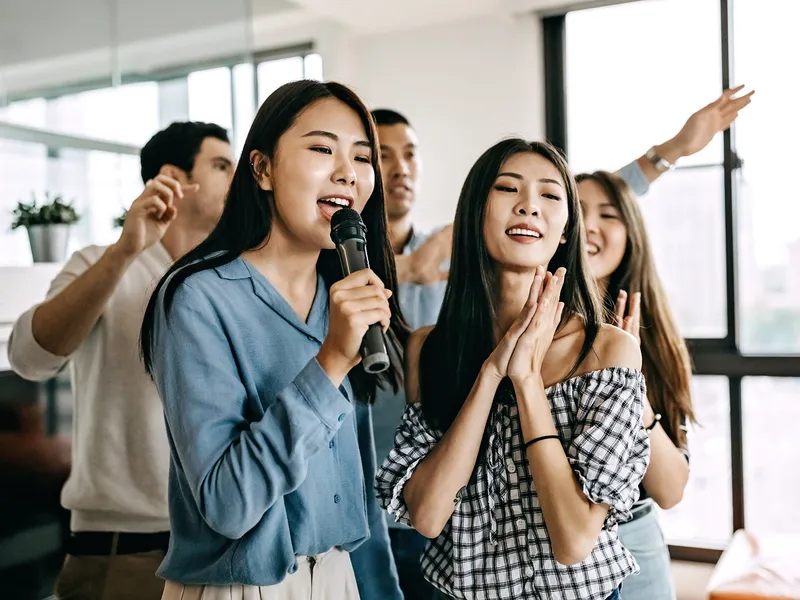 people singing with microphone