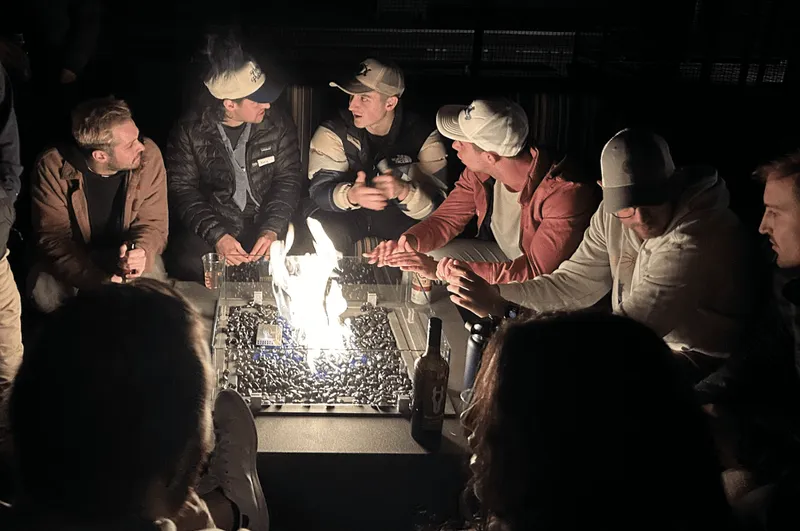 group of people gathering around a bonfire