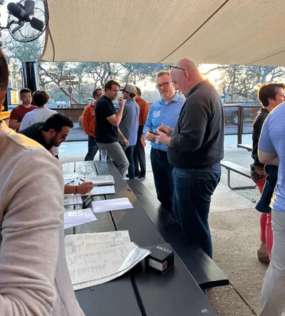 group of people outdoors with black table