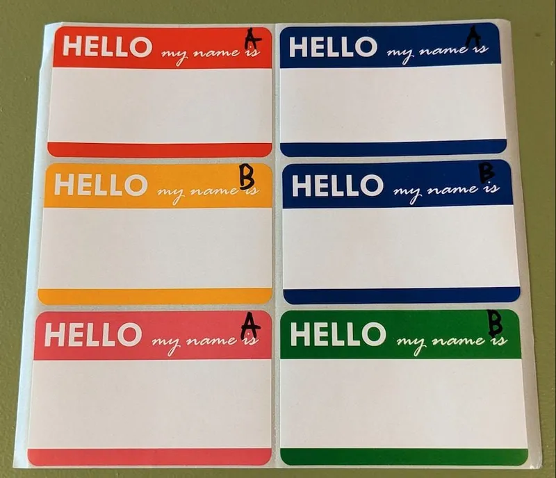 6 name tags colored red, yellow, blue, pink, and green