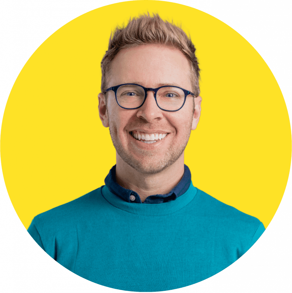 headshot photo of Nick Gray in yellow background