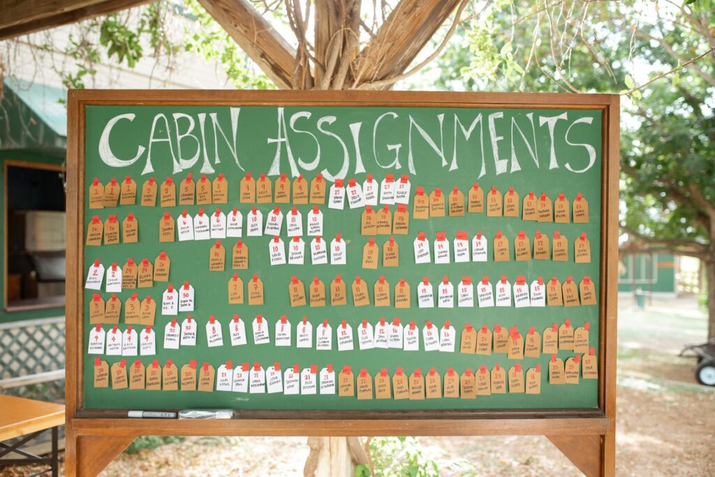 Cabin assignments posted on the blackboard for the adult summer camp