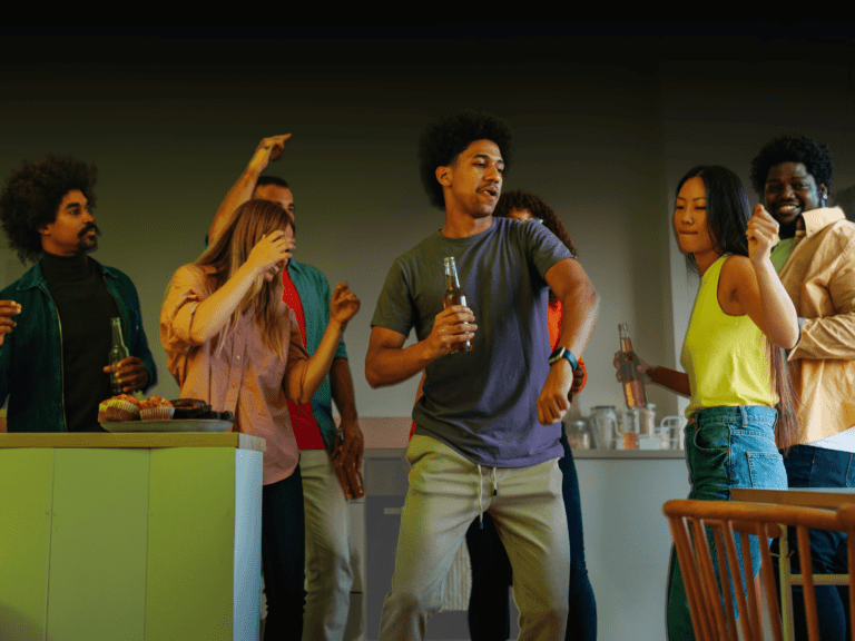 a group of people dancing and drinking